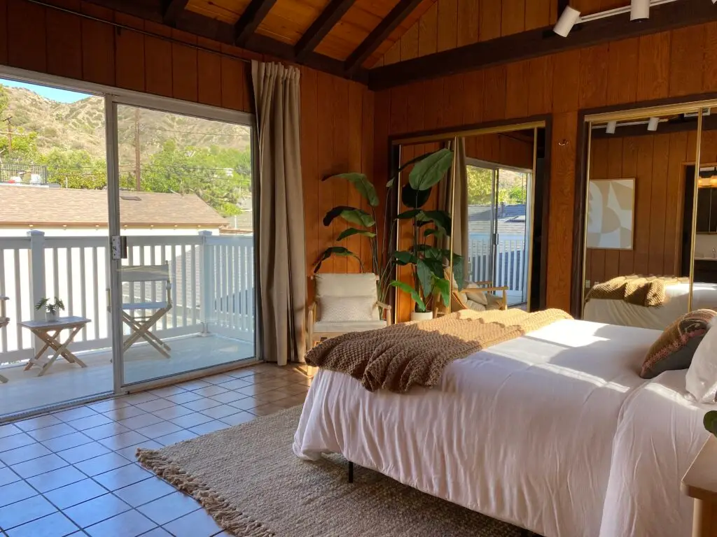 Primary bedroom in 736 Irving Drive Burbank Ranch Home with backyard access and wood flooring.